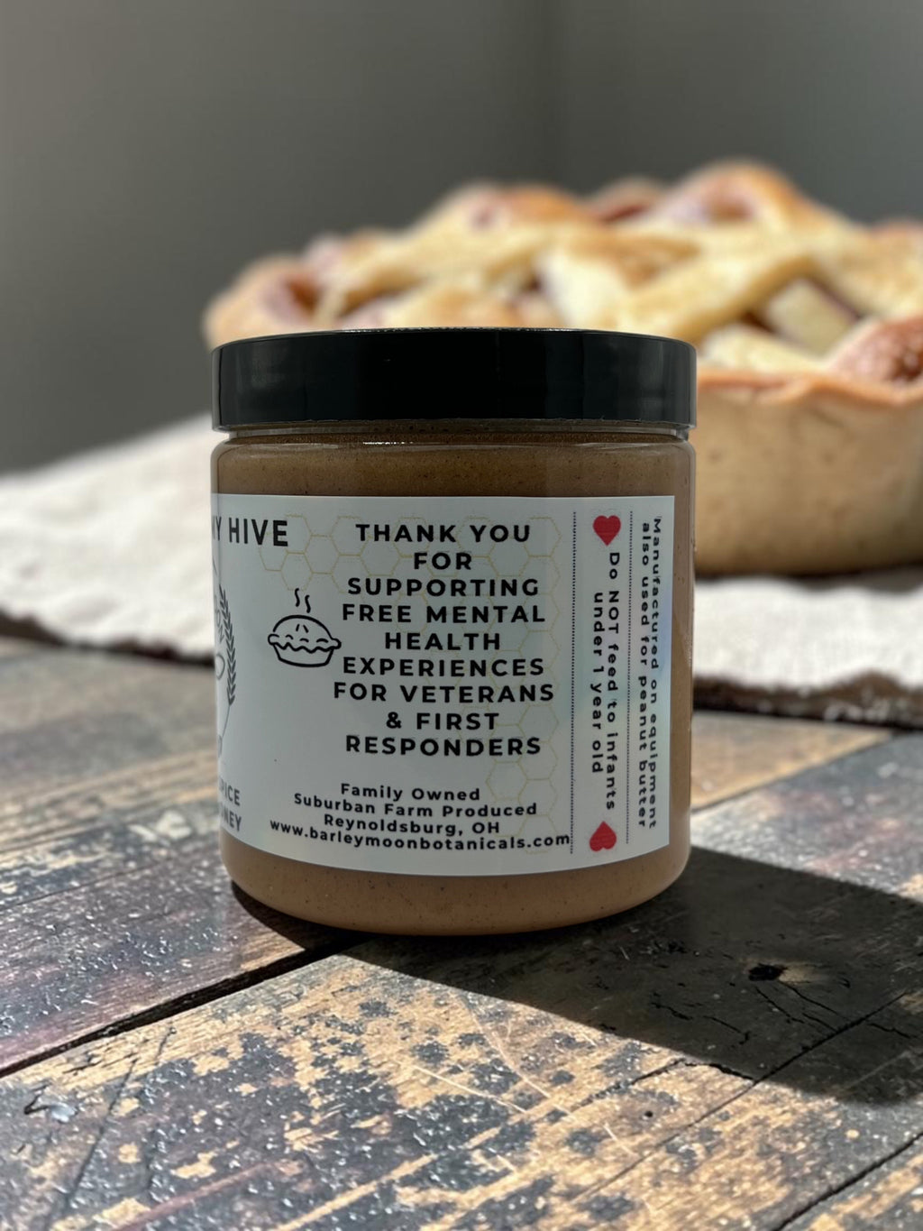 Barley Moon Botanicals Apple of My Hive creamed honey jar with apple pie spice, displayed on a rustic wooden table.