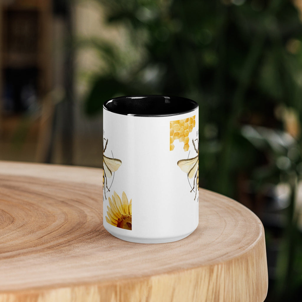 Barley Moon Botanicals 15oz ceramic mug with bee, flower, and honeycomb design and a black interior and handle.