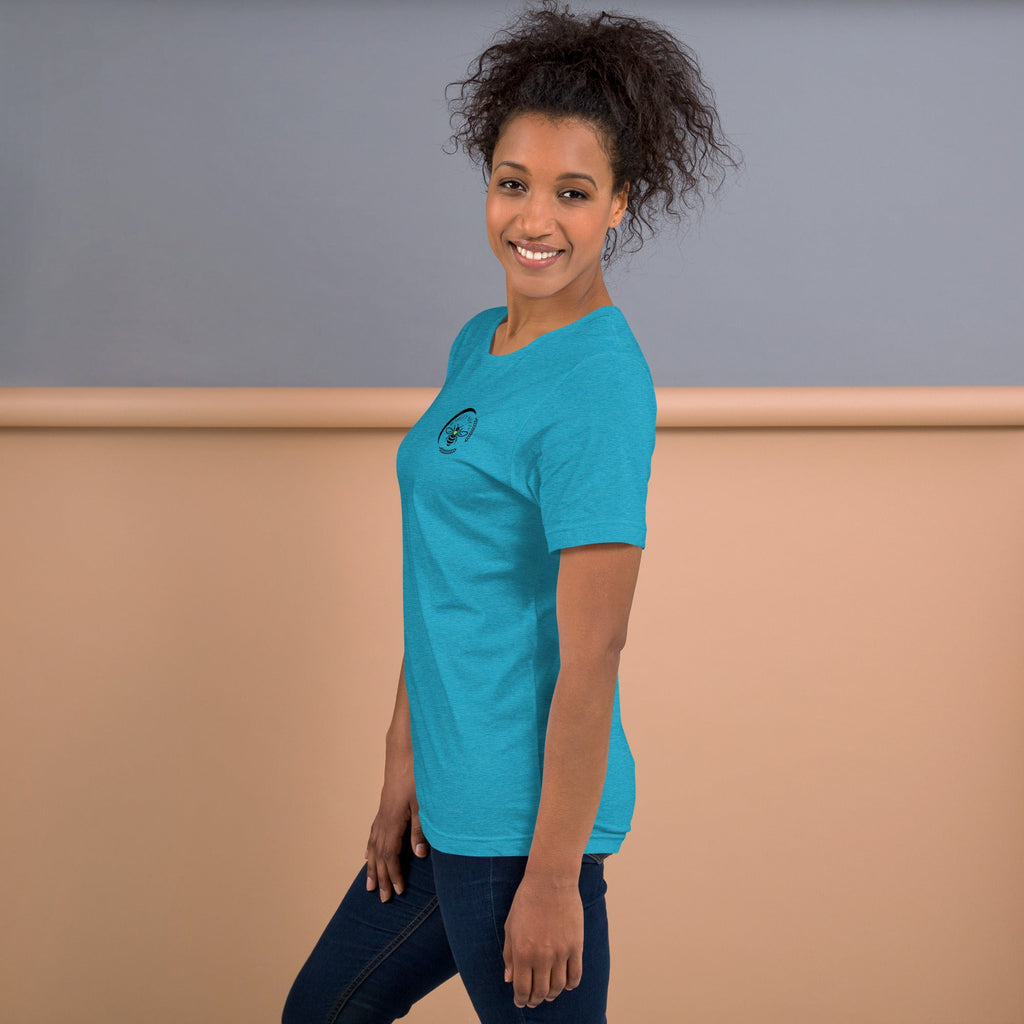 A woman wearing a bright blue Barley Moon Botanicals t-shirt with a small black bee and crescent moon logo on the chest