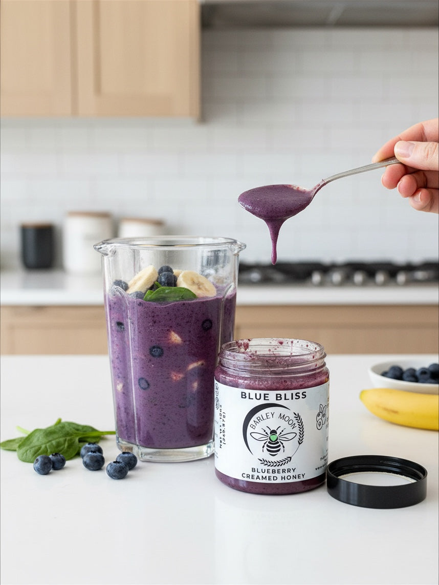 Barley Moon Botanicals Blue Bliss blueberry creamed honey jar next to a smoothie with blueberries and banana