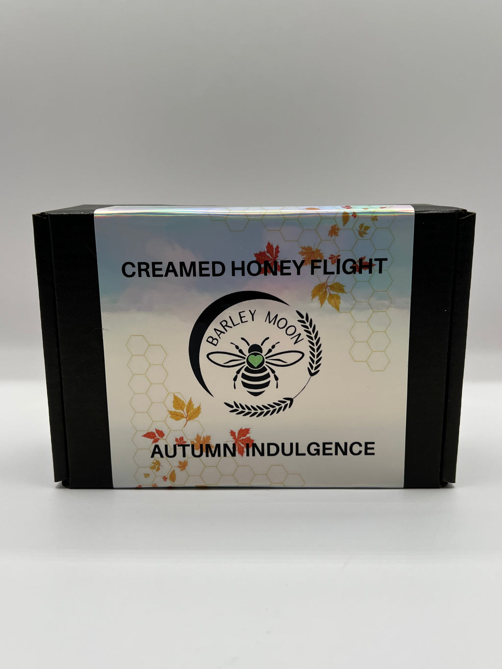 Barley Moon Botanicals Autumn Indulgence creamed honey flight set in a black box with holographic autumn leaf label