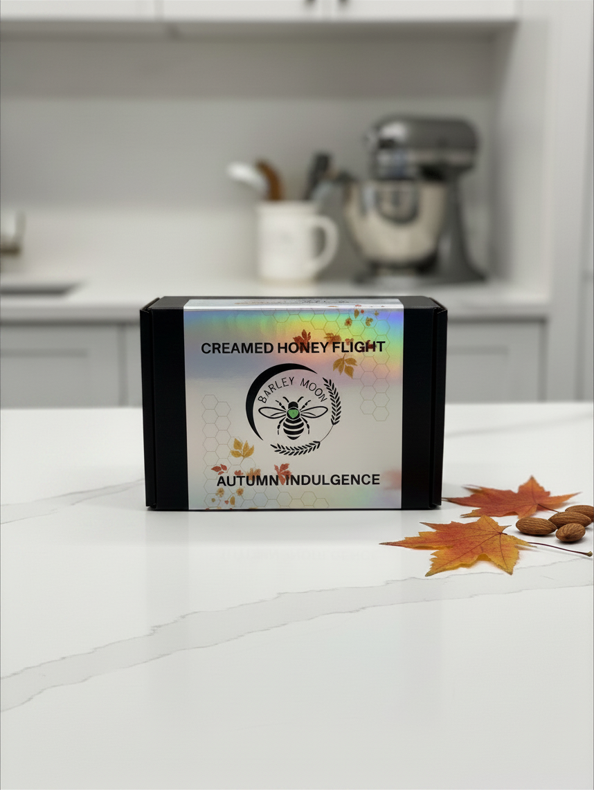 Barley Moon Botanicals Autumn Indulgence creamed honey flight box with holographic label on a white kitchen counter.