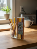 Barley Moon Botanicals Hive Five creamed honey straws in a clear pack and glass on a wooden kitchen counter.