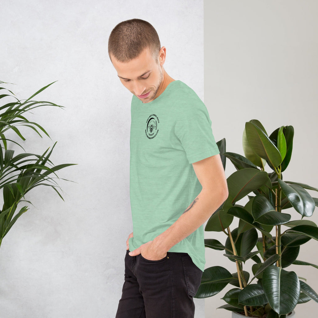 Barley Moon Botanicals unisex mint green t-shirt with a mental health bee graphic, worn by a man in a plant-filled room.