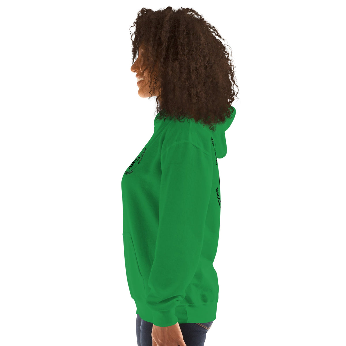 Side view of a woman wearing a green Barley Moon Botanicals unisex hoodie with a bee and crescent moon logo.