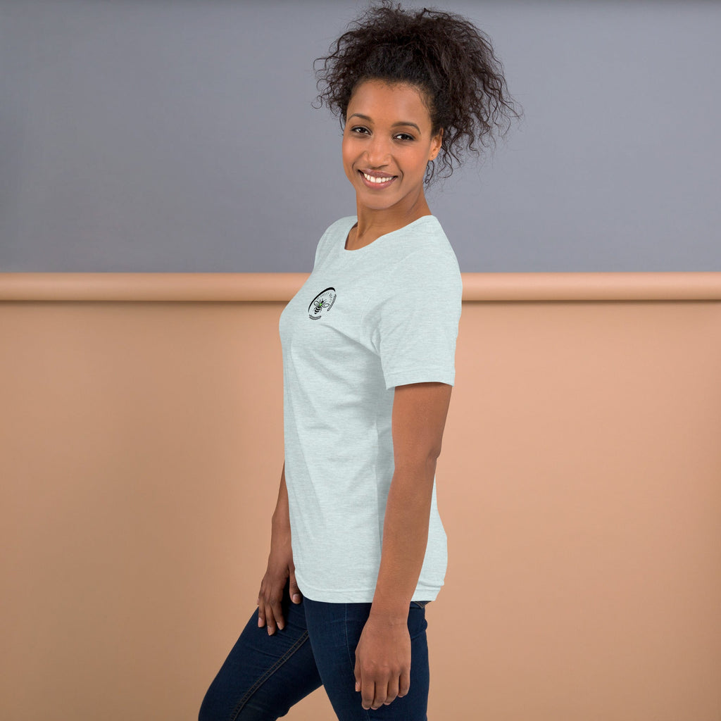 A woman wearing a light grey Barley Moon Botanicals t-shirt with a black bee and moon logo on the chest.