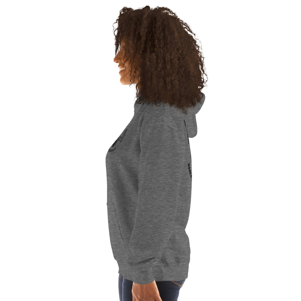 Side view of a woman wearing a dark grey Barley Moon Botanicals unisex hoodie with a bee and moon logo design.