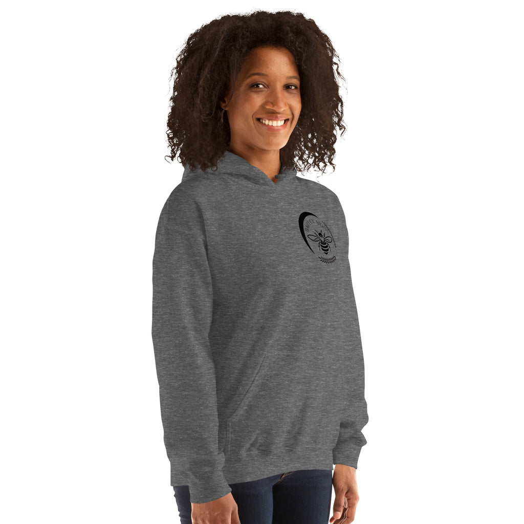 Woman wearing a grey Barley Moon Botanicals unisex hoodie with a black bee and crescent moon logo on the chest