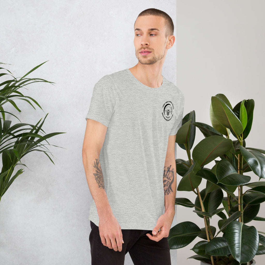 A man wearing a Barley Moon Botanicals grey heather unisex t-shirt with a small circular bee logo on the chest.