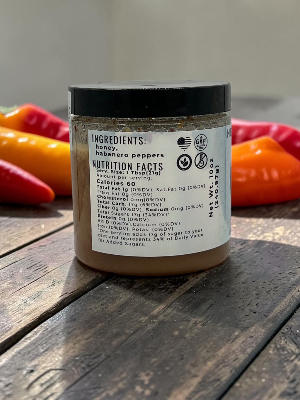Barley Moon Botanicals Habanero Honey jar showing nutrition facts and ingredients label on a rustic wooden surface.