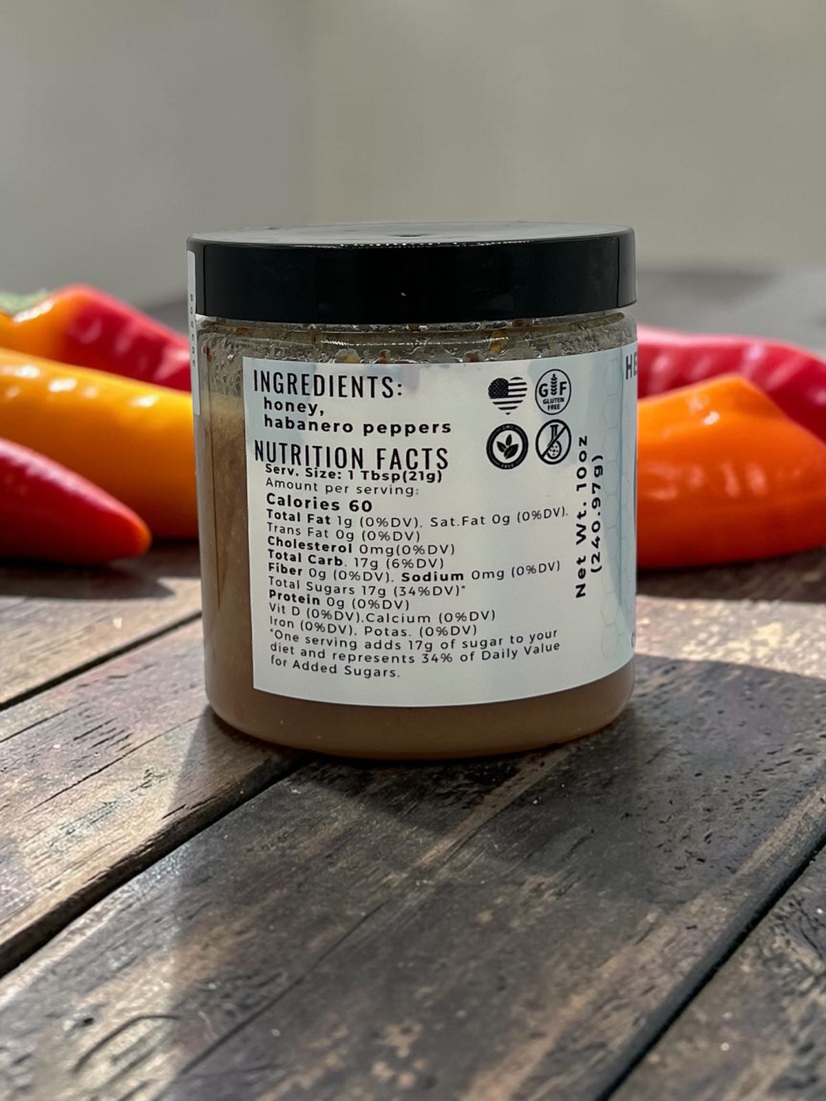 Barley Moon Botanicals Habanero Honey jar showing nutrition facts and ingredients label on a rustic wooden surface.