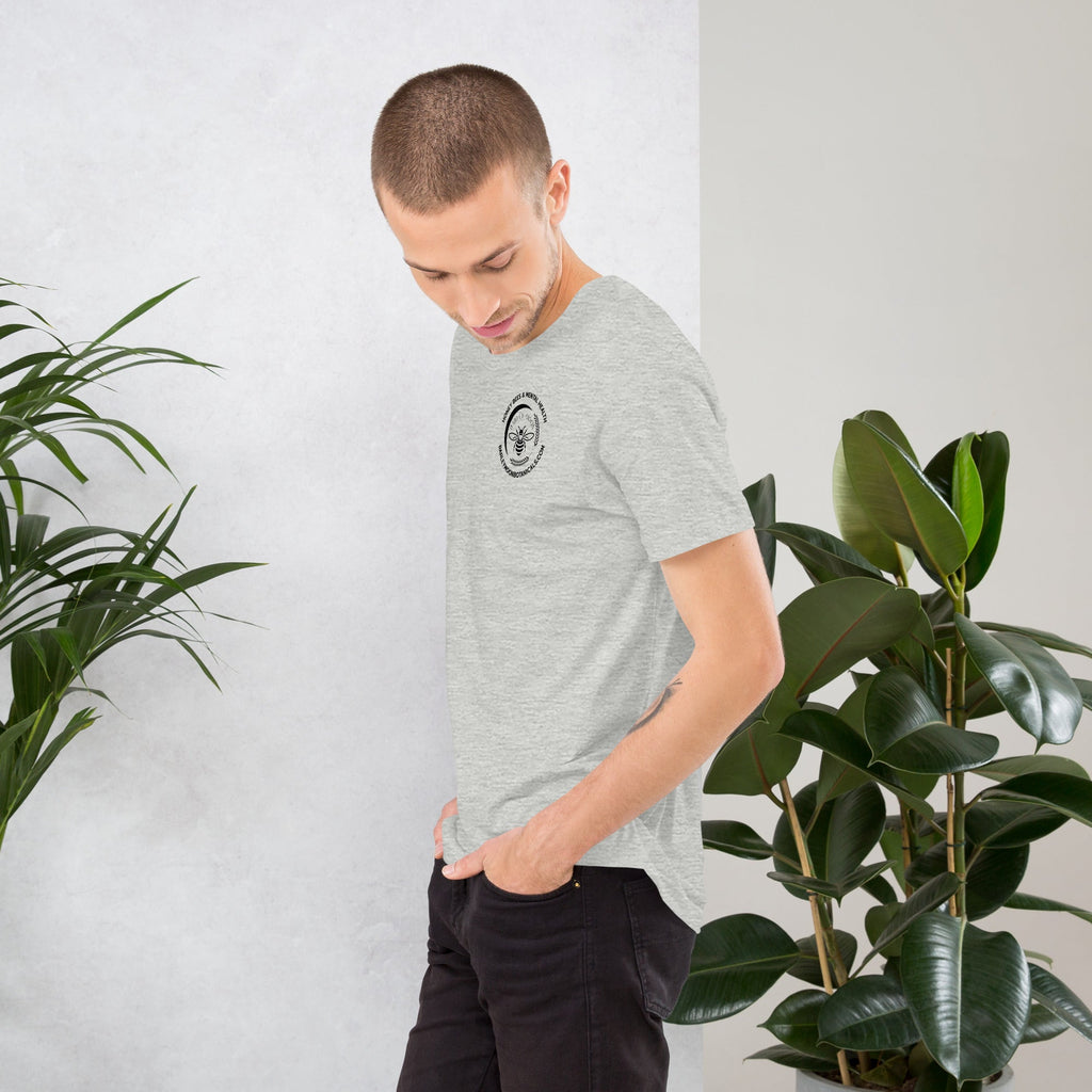 A man wearing a Barley Moon Botanicals heather grey unisex t-shirt with a small bee logo on the chest.