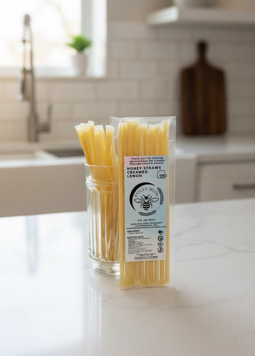 Barley Moon Botanicals lemon creamed honey straws in a clear package and glass jar on a kitchen counter