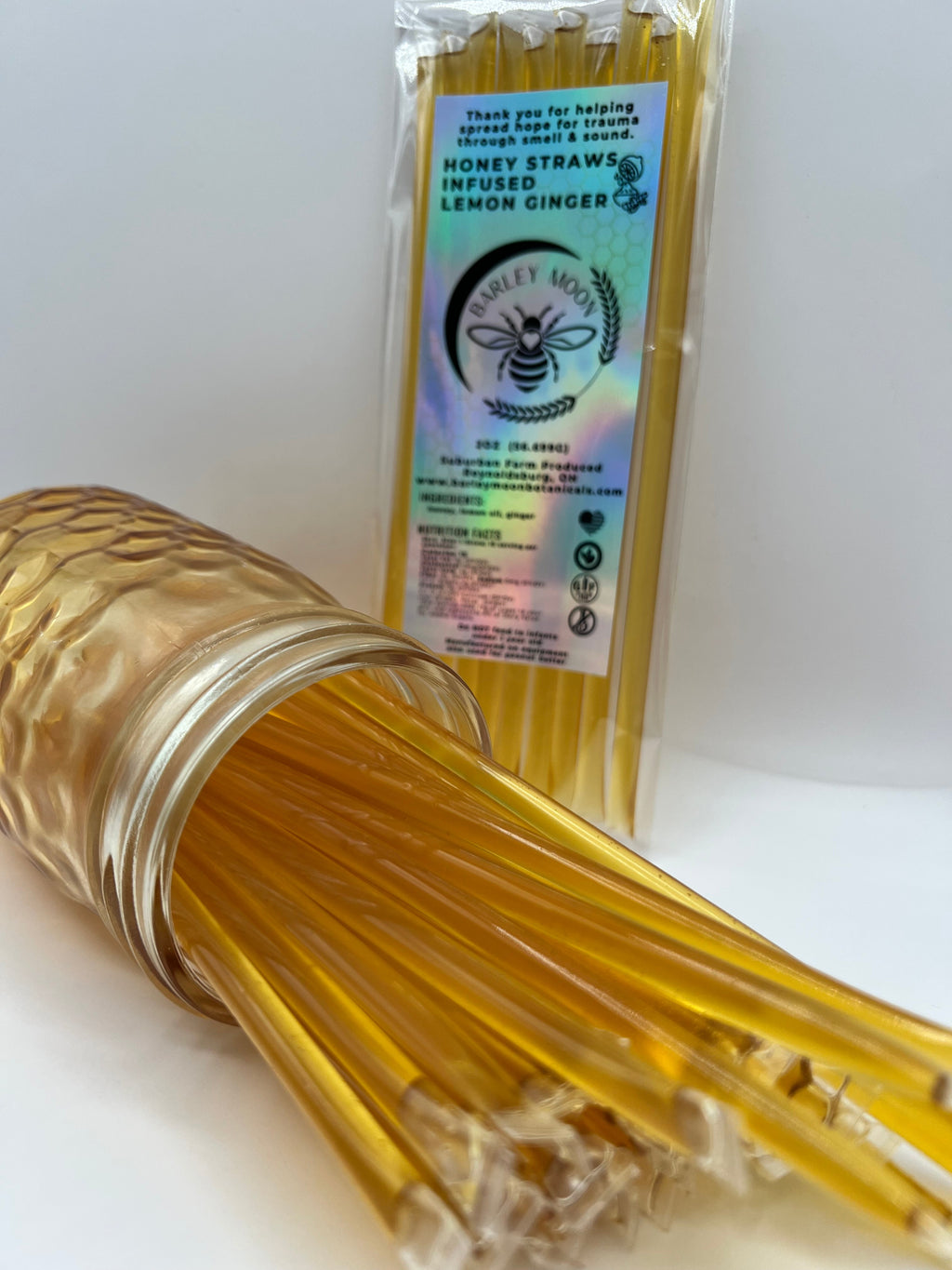 Barley Moon Botanicals lemon ginger honey straws in a glass jar with a holographic product label.