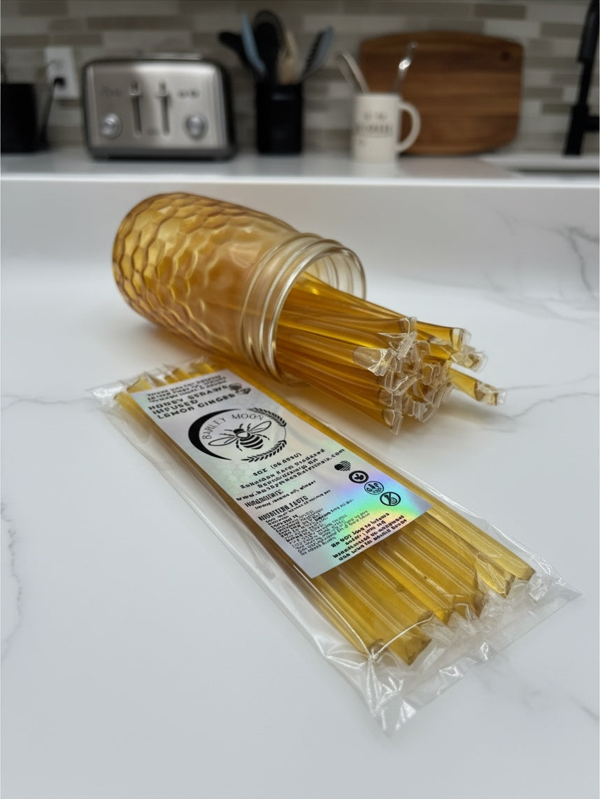 Barley Moon Botanicals lemon ginger honey straws in a clear plastic pack next to a honeycomb-textured glass jar.