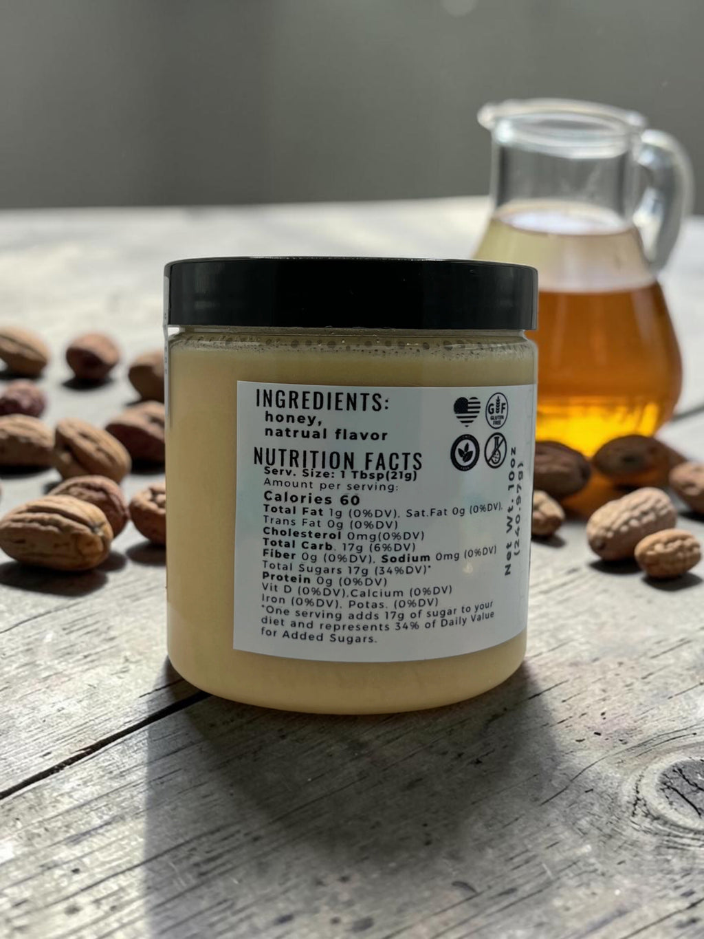Barley Moon Botanicals MapeCozy creamed honey jar showing nutrition facts label with pecans and honey on wood table