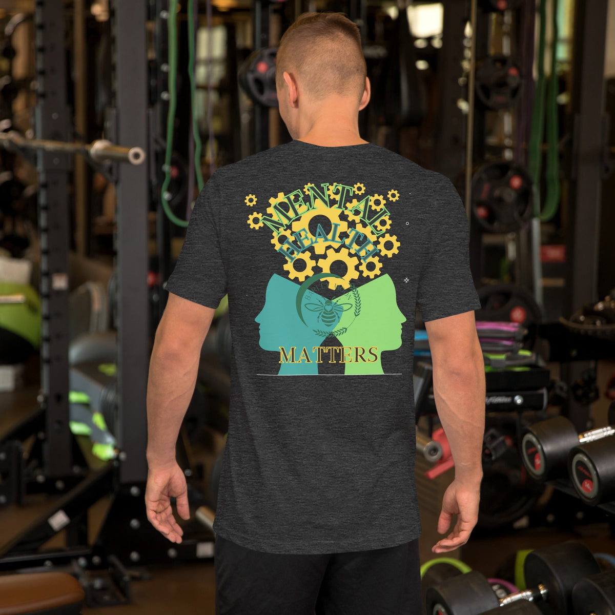 A man wearing a Barley Moon Botanicals charcoal grey cotton t-shirt with a mental health graphic on the back.