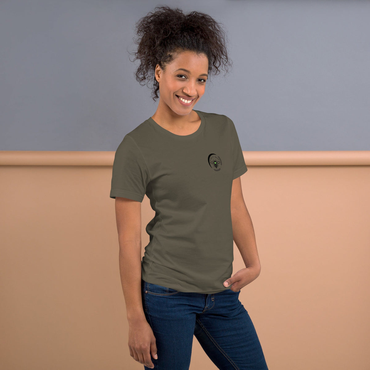 Woman wearing a Barley Moon Botanicals olive green cotton t-shirt with a black bee and crescent moon logo