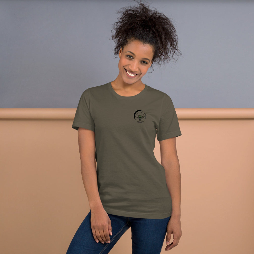 A woman wearing a Barley Moon Botanicals olive green cotton t-shirt with a black bee and crescent moon logo.