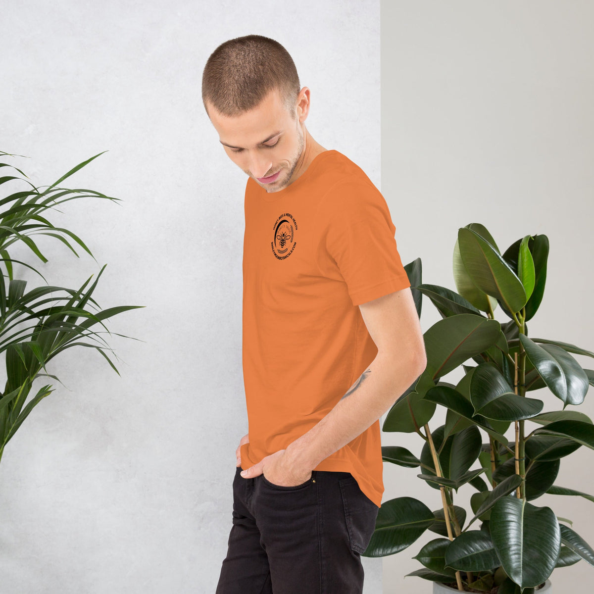 Barley Moon Botanicals orange unisex t-shirt with a small bee and mental health graphic on the chest.