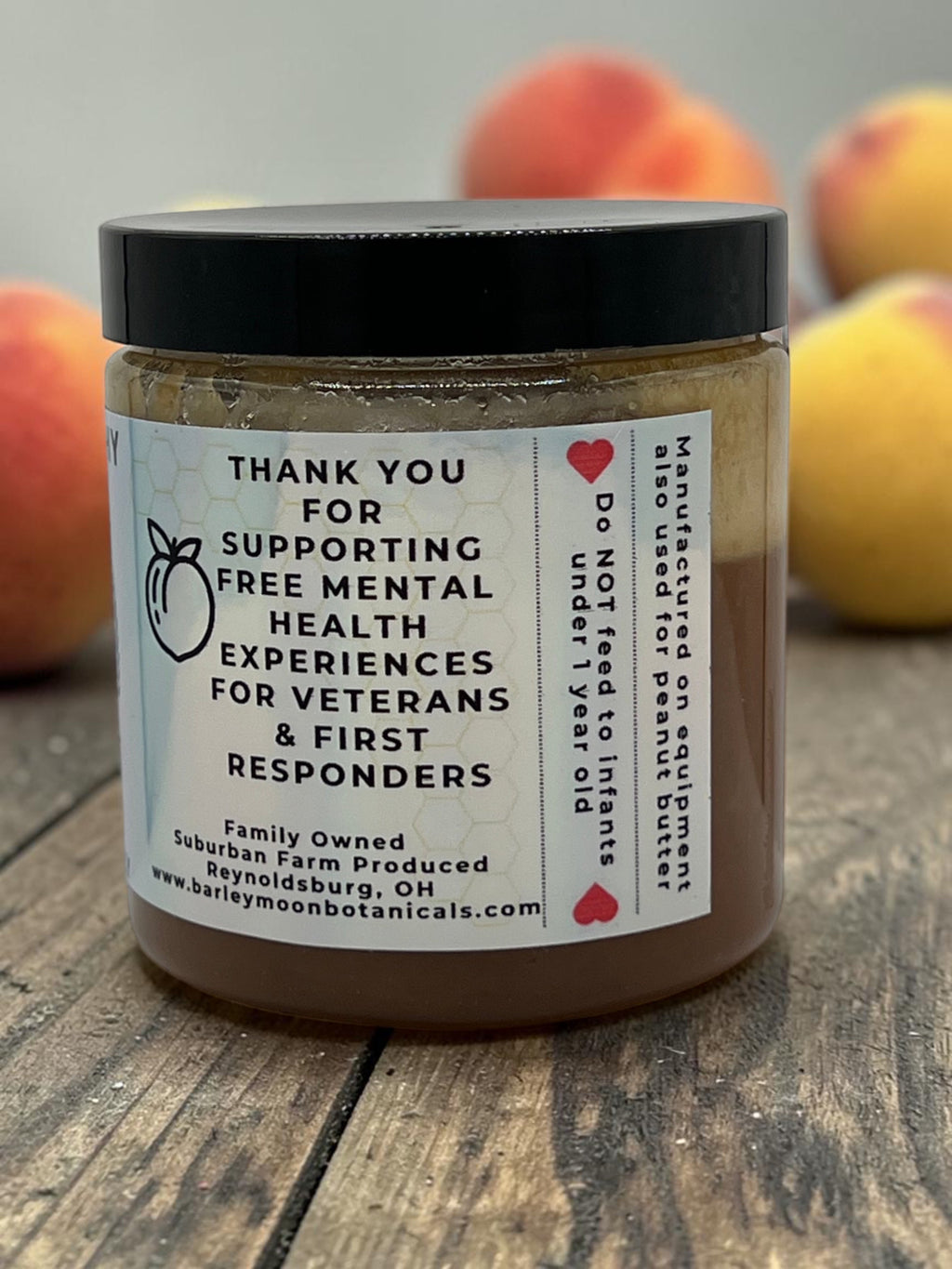 Barley Moon Botanicals Just Peachy creamed honey jar with label detailing support for veterans and first responders