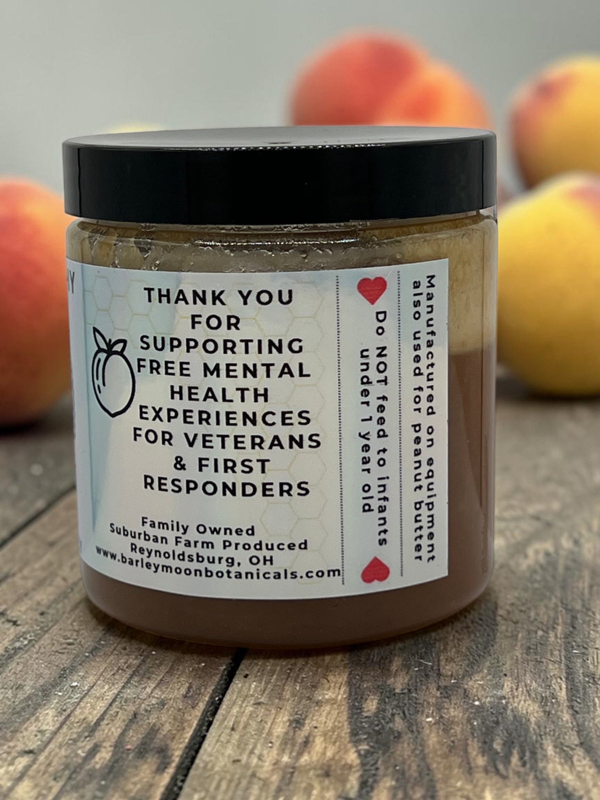 Barley Moon Botanicals Just Peachy creamed honey jar with label detailing support for veterans and first responders