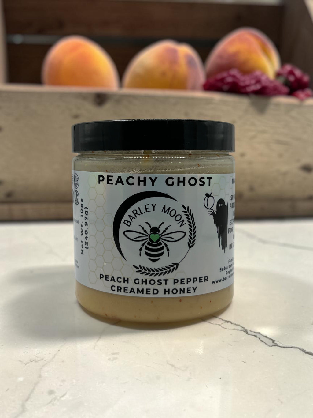 Barley Moon Botanicals Peachy Ghost creamed honey jar with peach ghost pepper in a clear glass container