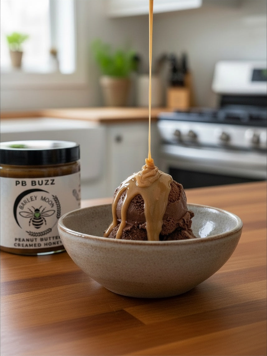 Barley Moon Botanicals PB Buzz peanut butter creamed honey drizzled over a scoop of chocolate ice cream in a bowl