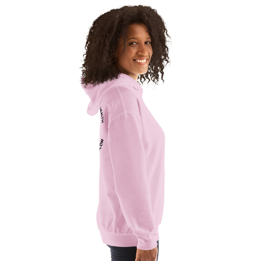 A smiling woman wearing a light pink Barley Moon Botanicals unisex hoodie with a side view showing the back design.