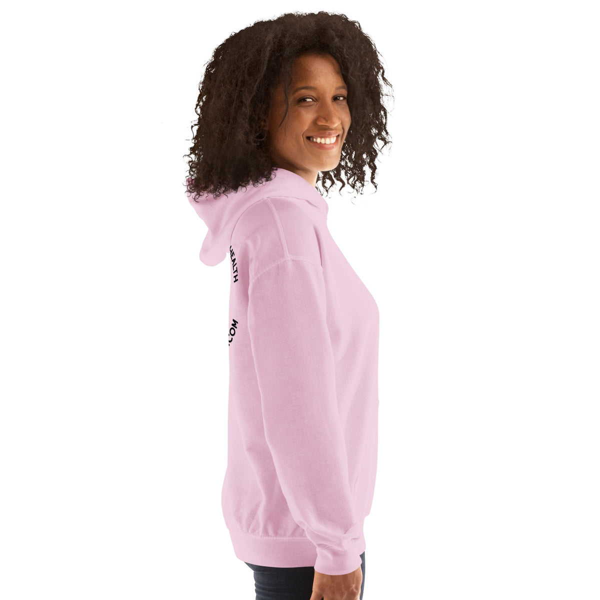 A smiling woman wearing a light pink Barley Moon Botanicals unisex hoodie with a side view showing the back design.