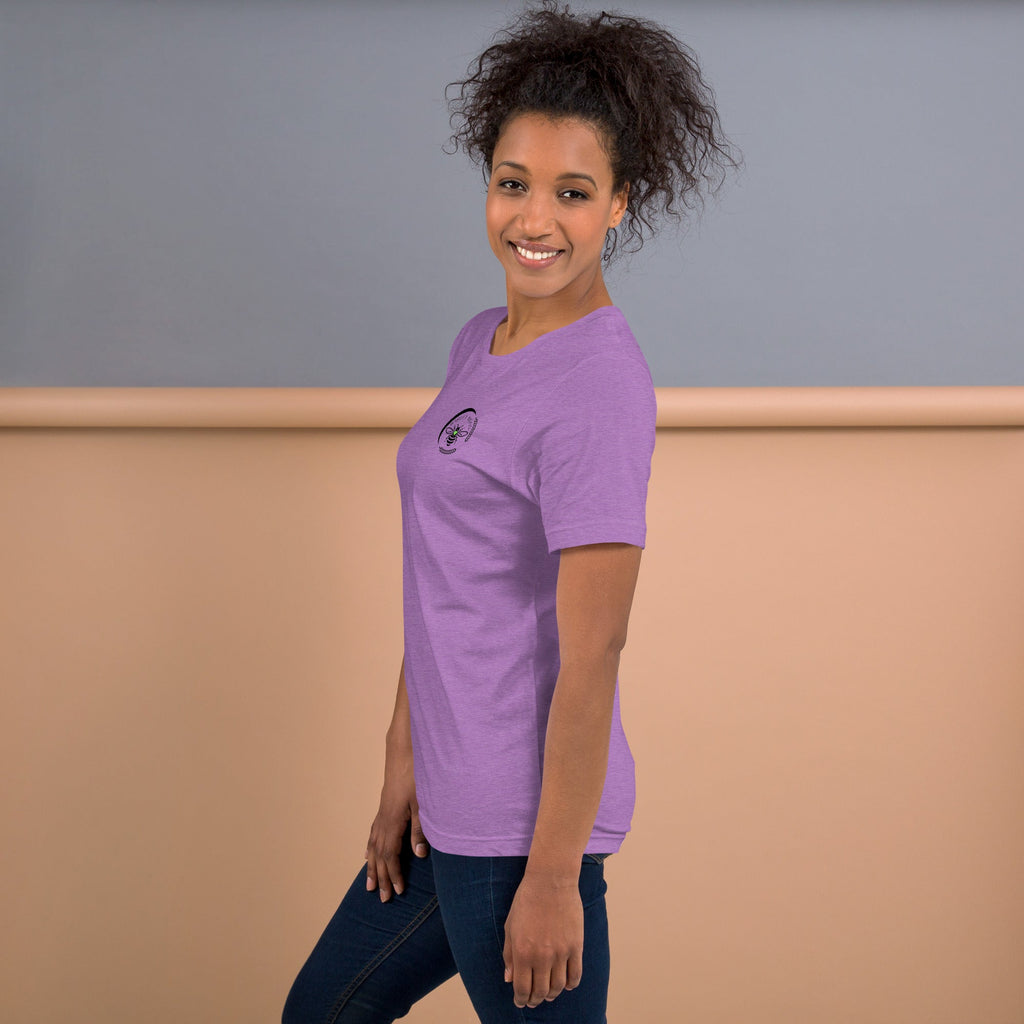 A woman wearing a purple Barley Moon Botanicals t-shirt with a bee and crescent moon logo, side profile view.
