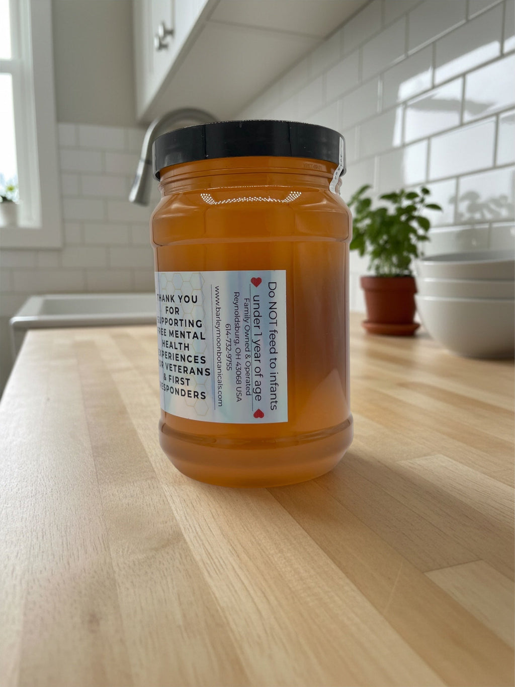 Barley Moon Botanicals 3lb jar of pure raw unfiltered local honey on a kitchen counter