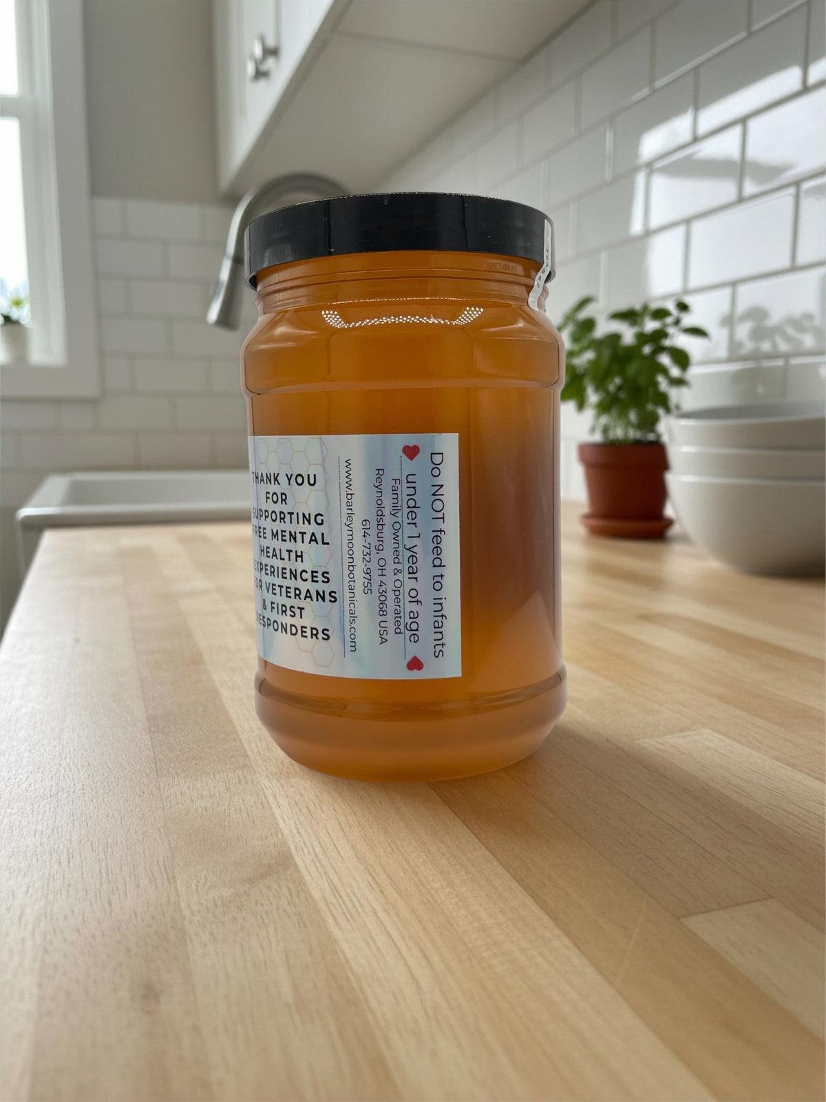 Barley Moon Botanicals 3lb jar of pure raw unfiltered local honey on a kitchen counter