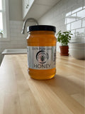 Barley Moon Botanicals 3lb jar of pure raw unfiltered local honey on a wooden kitchen counter