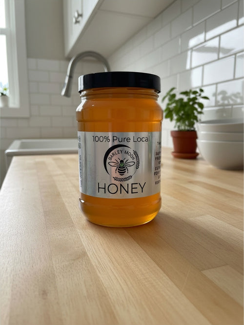 Barley Moon Botanicals 3lb jar of pure raw unfiltered local honey on a wooden kitchen counter