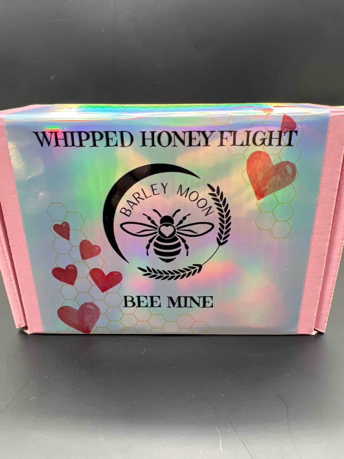 Barley Moon Botanicals Bee Mine Whipped Honey Flight box with iridescent finish and heart illustrations.