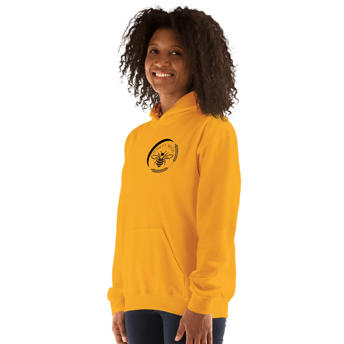 Barley Moon Botanicals unisex yellow hoodie featuring a black bee and crescent moon logo on a smiling woman
