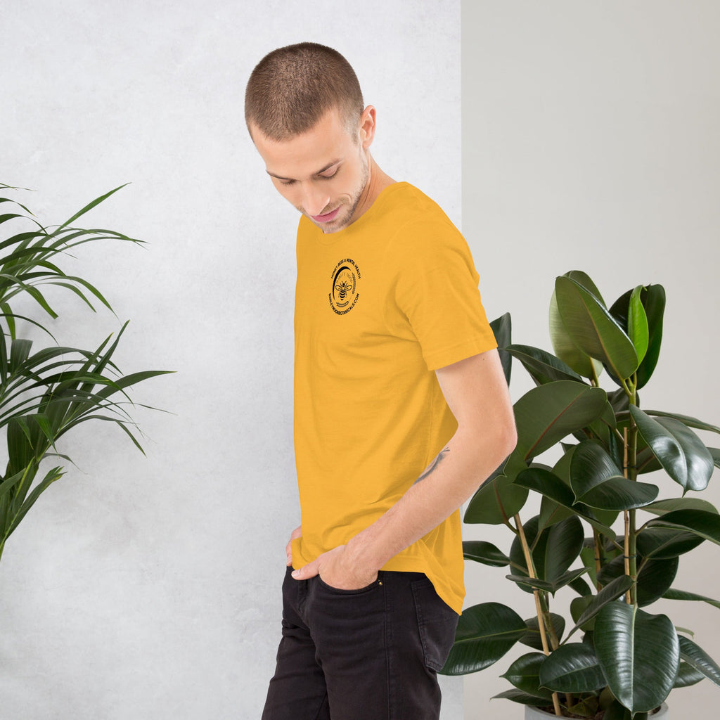 Barley Moon Botanicals unisex yellow t-shirt with a small bee logo on the chest, worn by a man in a studio setting.